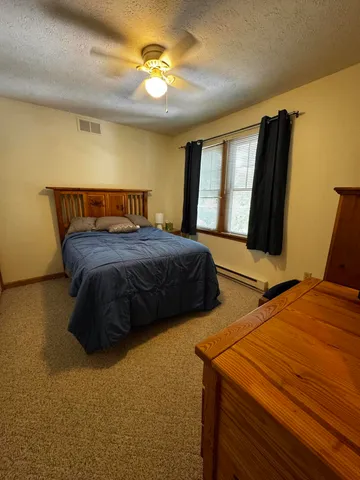 a bedroom with double bed and a window