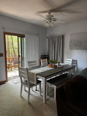 a view of a dining room with furniture window and outside view