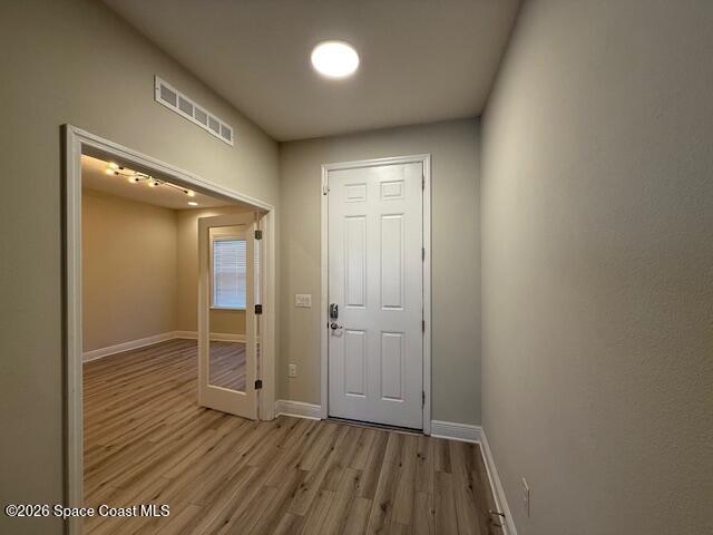 4570 Hebron Drive Merritt Island, FL 32953 - Photo 3 of 23 an empty room with wooden floor and entrance