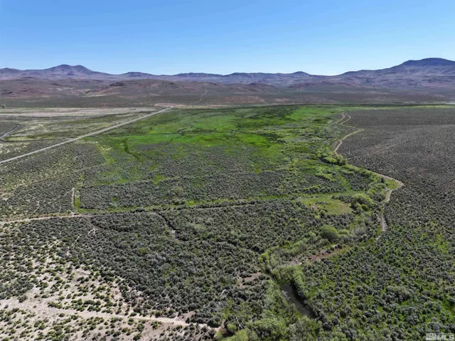 a view of a lush green hillside and a building