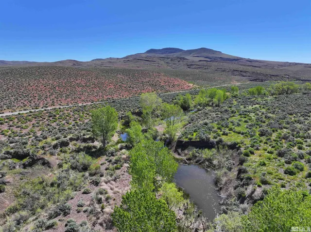 a view of a lush green hillside and a building
