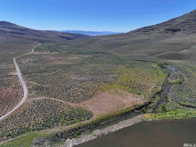 a view of a yard with a wooden fence