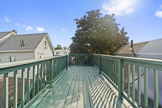 a view of balcony with wooden floor and fence