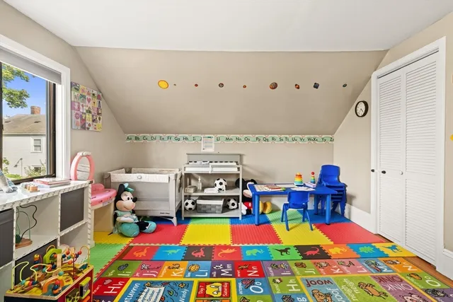 a room with furniture and a baby crib