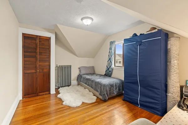 a bedroom with a bed and a closet