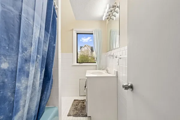 a bathroom with a sink and mirror with toilet