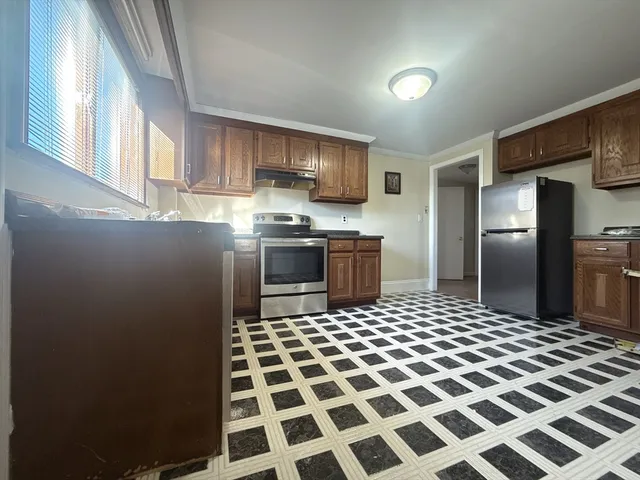 a kitchen with stainless steel appliances granite countertop a refrigerator and a sink