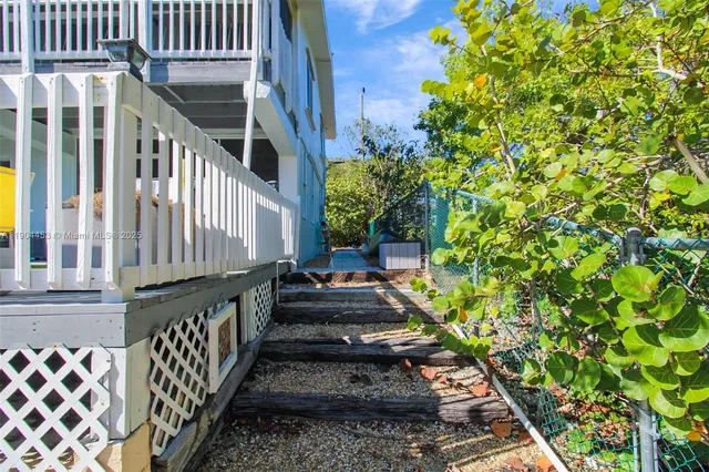 a view of a pathway of house with wooden stairs