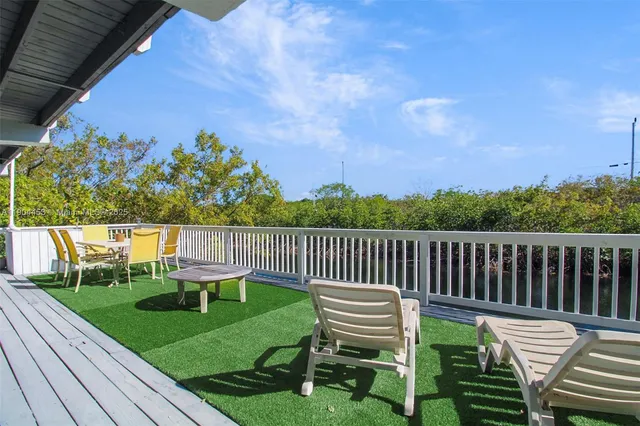 a balcony with wooden floor and fence