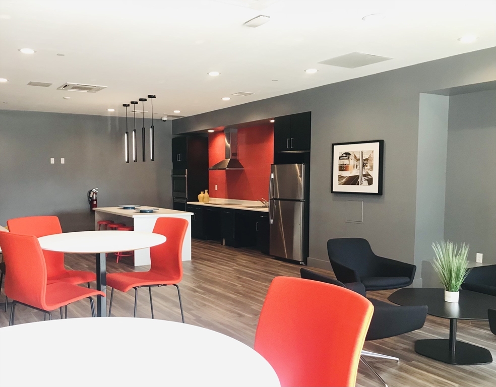 466 River Street, Unit 516 Boston, MA 02126 - Photo 14 of 16 a living room with furniture a rug and a lamp