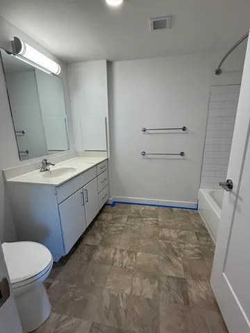a bathroom with a sink a toilet and mirror