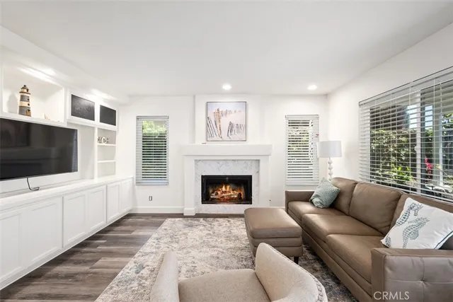 a living room with furniture a flat screen tv and a fireplace