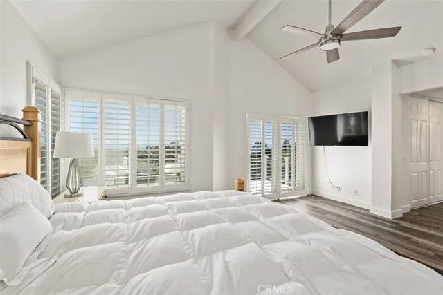 a view of a spacious bedroom with a large window