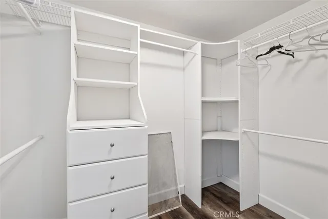 a view of walk in closet with empty racks