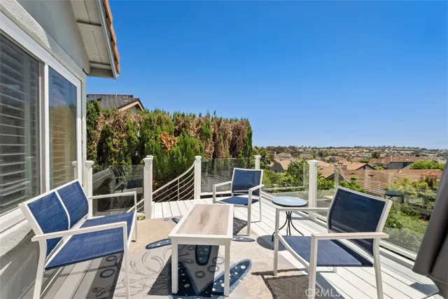 a view of a patio with lawn chairs