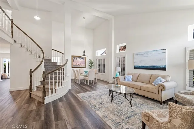 a living room with furniture and a table with wooden floor