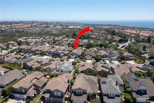 an aerial view of a residential houses with outdoor space