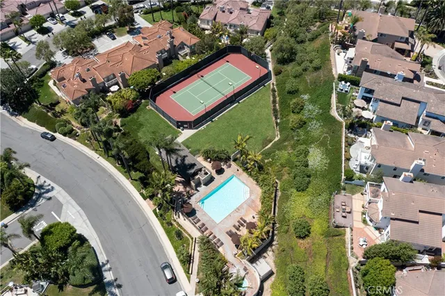 a aerial view of a house with a yard table and chairs