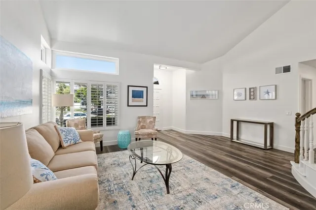 a living room with furniture wooden floor and a table