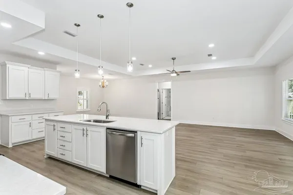 a kitchen with a sink and chandelier