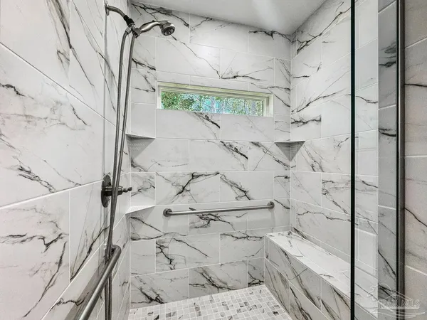 a bathroom with a shower and a mirror