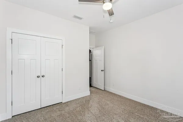 an empty room with a ceiling fan