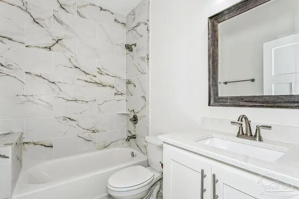 a bathroom with a sink toilet a bathtub and shower
