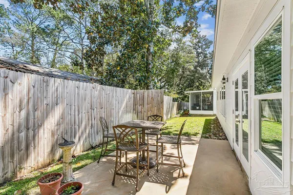 a view of outdoor dining space with a patio and backyard