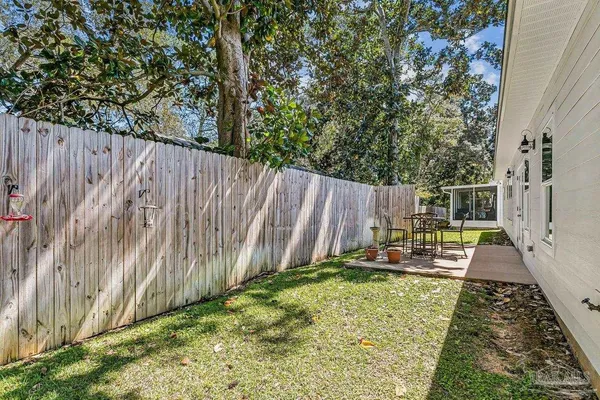 a view of a backyard with wooden fence