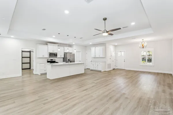 a view of kitchen with cabinets and wooden floor