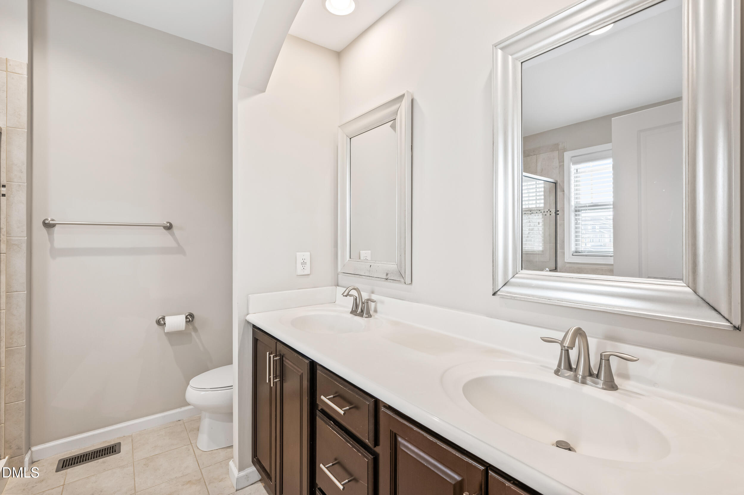 1301 Oatney Ridge Lane Morrisville, NC 27560 - Photo 30 of 38 a bathroom with a double vanity sink toilet and a mirror