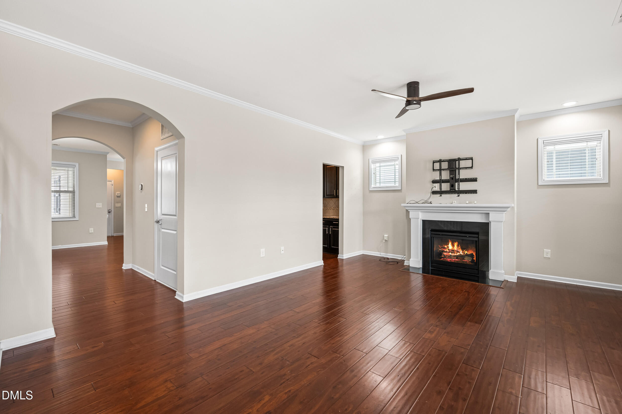 1301 Oatney Ridge Lane Morrisville, NC 27560 - Photo 6 of 38 a view of a livingroom with wooden floor a fireplace and windows