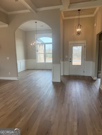a view of a livingroom with a fireplace a ceiling fan and wooden floor