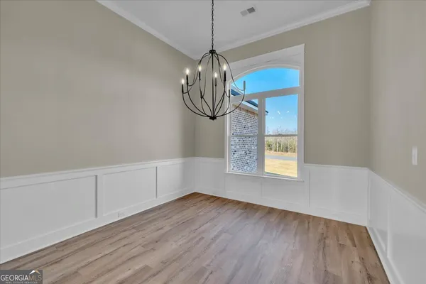 a kitchen with stainless steel appliances a sink a stove a refrigerator a center island and cabinets