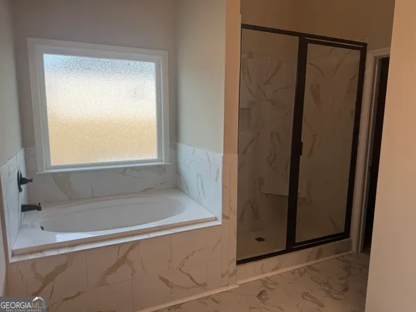 a view of empty room with wooden floor and fireplace