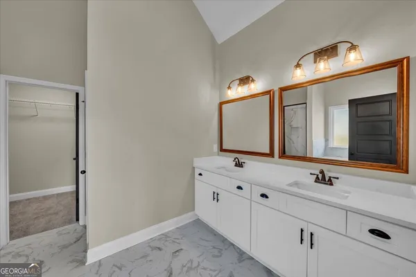 a view of a big room with chandelier fan and windows