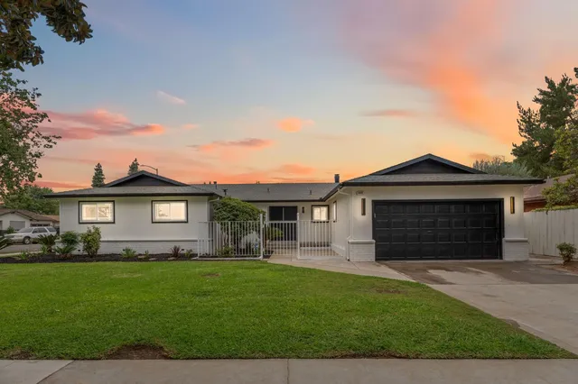 a front view of a house with a garden