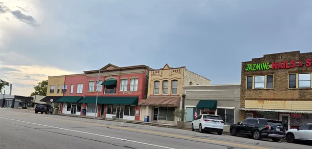 a view of a street that has couple of cars parked on the road