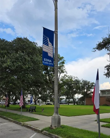 a street sign on a sidewalk next to a road