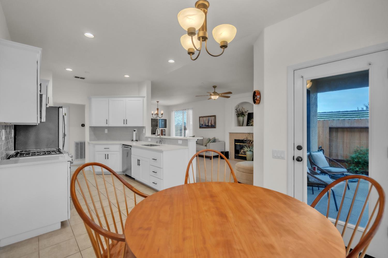 3509 Boulder Ridge Court Rocklin, CA 95765 - Photo 7 of 46 a open kitchen with stainless steel appliances granite countertop a stove top oven a sink dishwasher a dining table and chairs with wooden floor