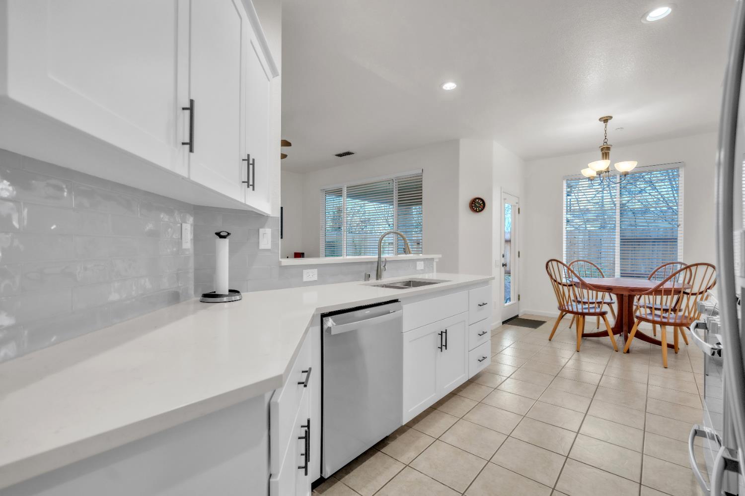 3509 Boulder Ridge Court Rocklin, CA 95765 - Photo 8 of 46 a kitchen with a sink and chairs