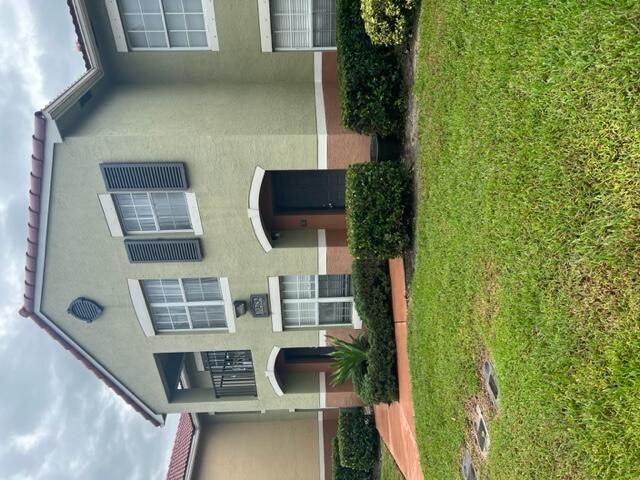a front view of a house with garden and porch