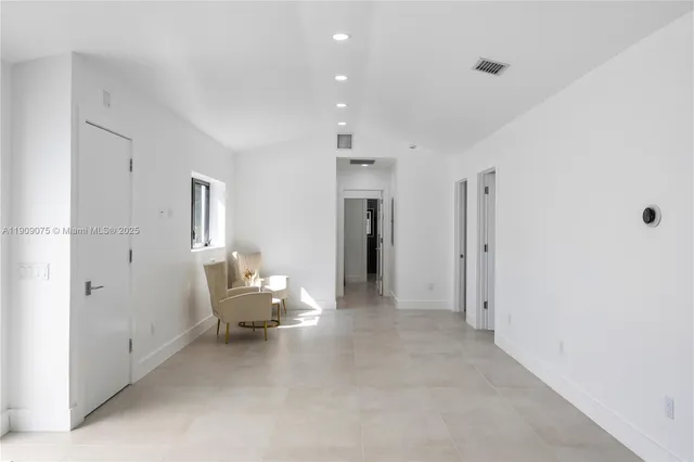 a living room with furniture and white walls