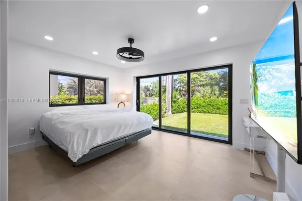 a bedroom with a large bed and a large window