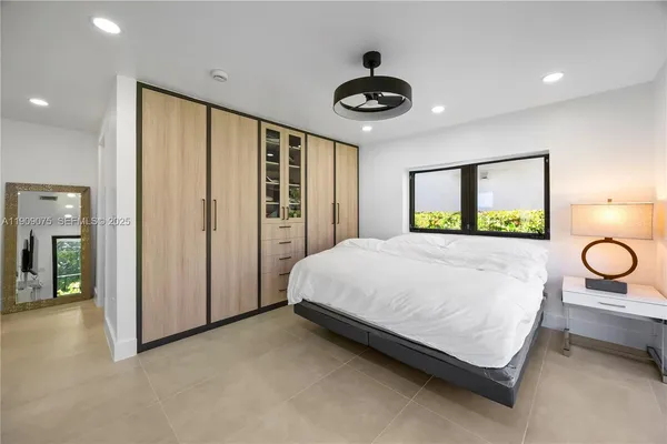 a bed room with a bed and a large window