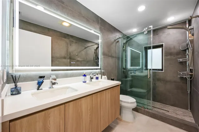 a bathroom with a sink toilet and shower