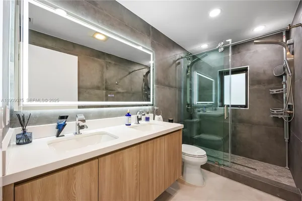 a bathroom with a sink toilet and shower