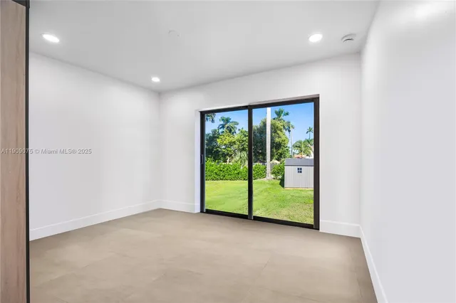 an empty room with wooden floor and balcony