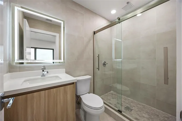 a bathroom with a sink toilet and shower