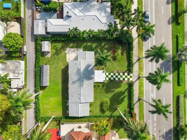 an aerial view of a house with a yard basket ball court and outdoor seating